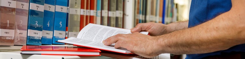 Man leafing through an open book